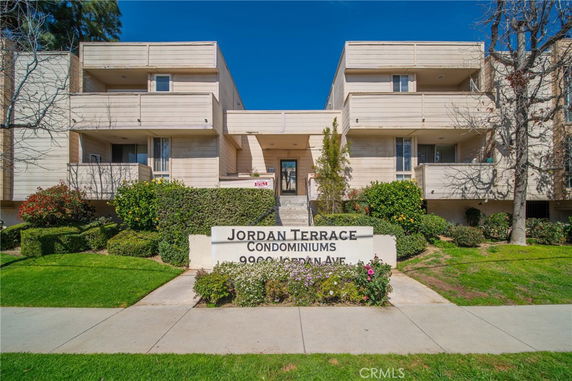 Front view of a condominium building with balconies.