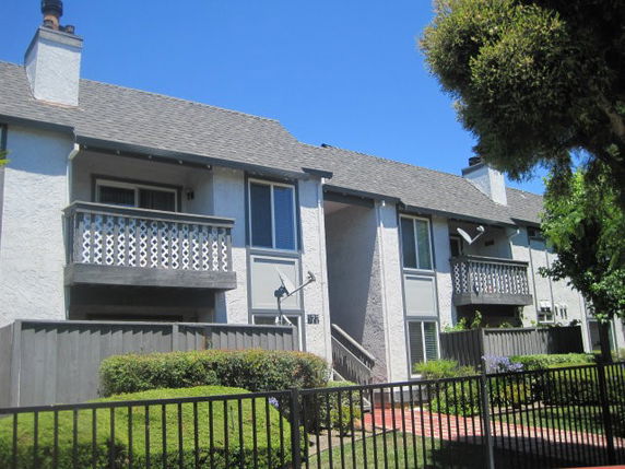 Front view of a two-story residential building with balconies.