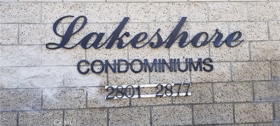 Front view of a condominium building with a sign reading 'Lakeshore Condominiums 2801-2877'.