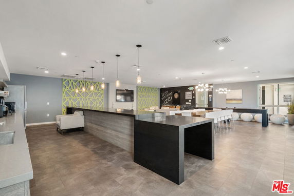Interior view of a clubhouse with seating areas and modern decor.