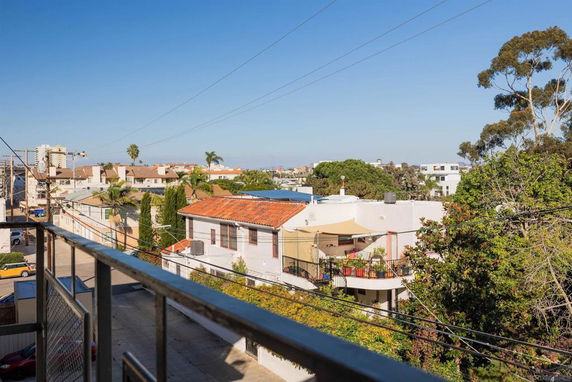 View from a building showing surrounding residential area with houses and trees.