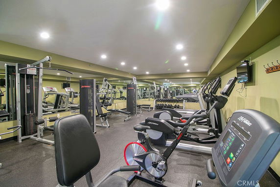 Interior view of a gym with various fitness equipment.