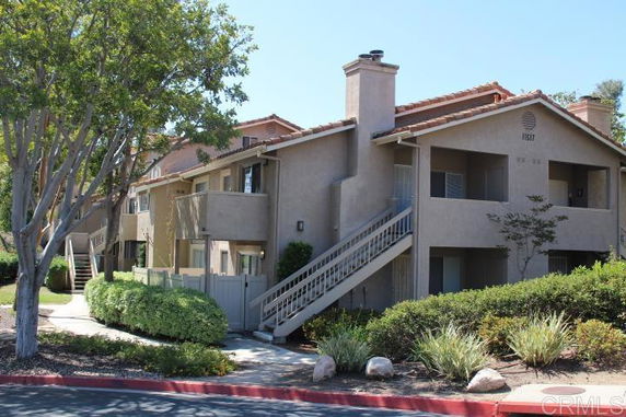 Front view of a two-story building with exterior staircases and balconies.