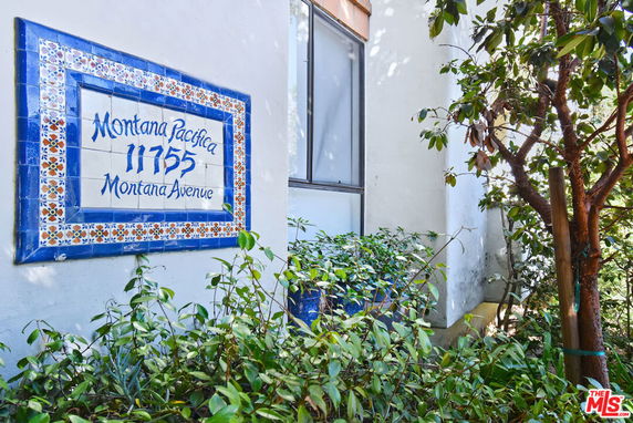Exterior view of a building with a decorative tiled address sign.
