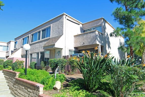 Front view of a two-story house with a modern design and multiple windows.