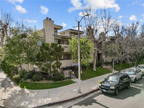 Front view of a multi-story residential building with balconies.