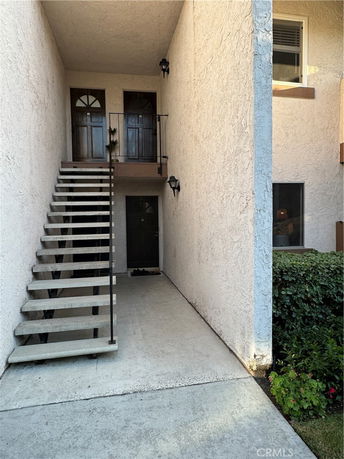 Entrance area with stairs and multiple doors leading to apartments.