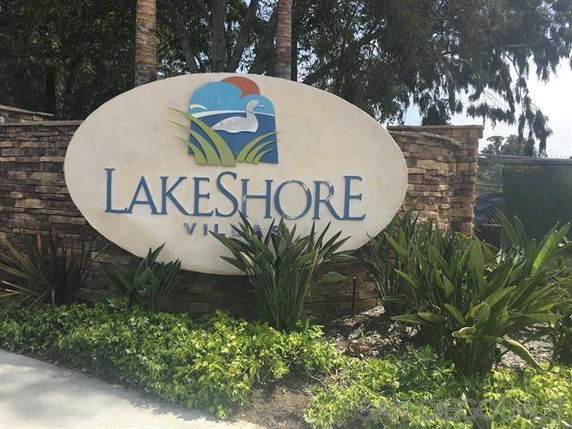 Entrance sign for Lakeshore Village with landscaping.