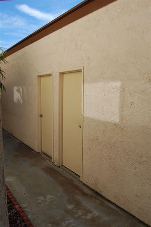 Side view of a building with two beige doors.