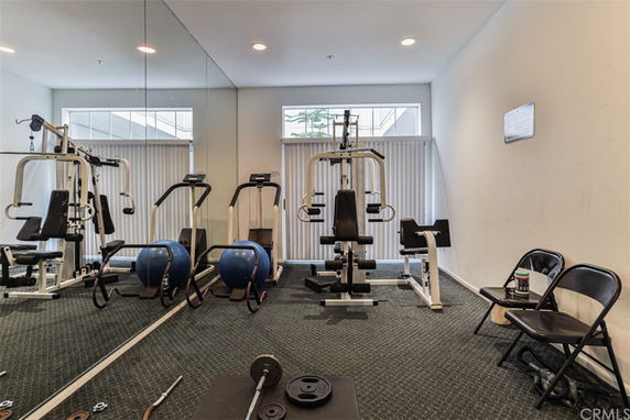 Indoor gym area with exercise equipment and mirrors.