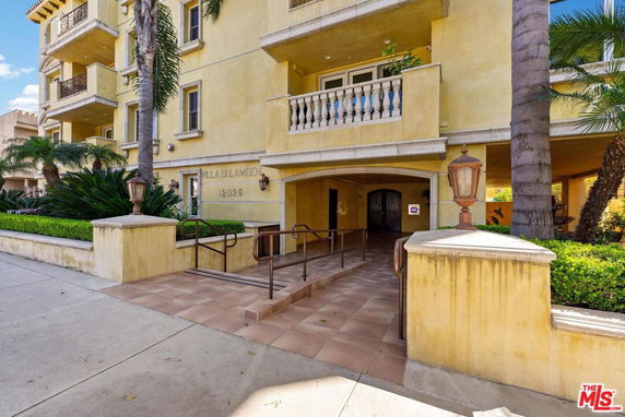 Front view of a multi-story residential building with balconies.