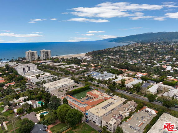 Panoramic view of coastal cityscape with buildings and ocean in the background.