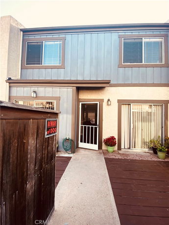 Front view of a two-story house with a walkway leading to the entrance.