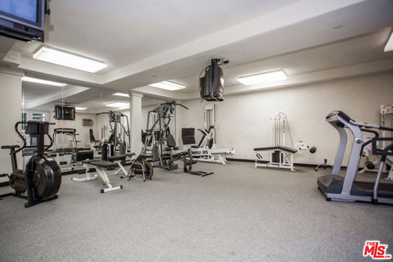 Indoor gym with exercise equipment and mirrors