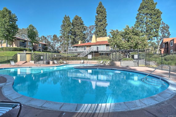 Outdoor area featuring a swimming pool with surrounding lounge chairs.