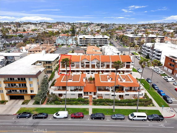 Aerial view of a residential area with multiple buildings featuring red-tiled roofs.