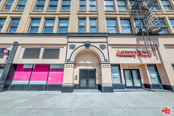 Front view of a multi-story building with a wedding chapel and a T-Mobile store.