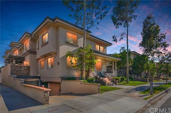 Front view of a two-story house with a garage underground.