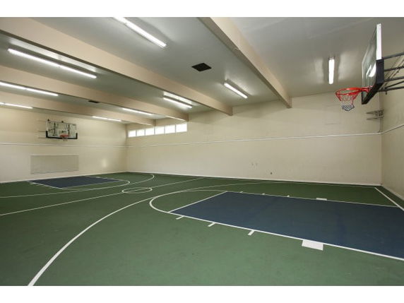 Indoor basketball court with two hoops and lined floor