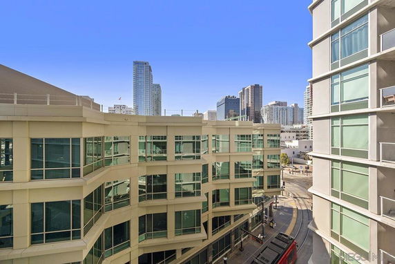 View of modern buildings in an urban setting with large windows.