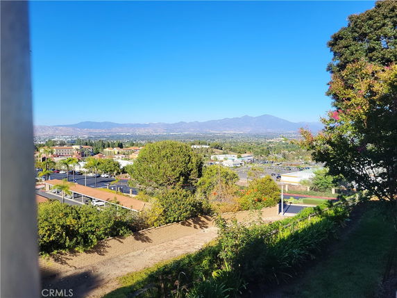 Panoramic view of a cityscape with mountains in the background.