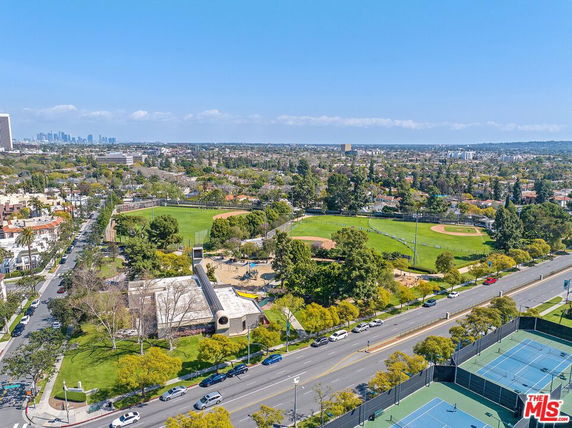 Wide angle view of a cityscape with parks and sports fields.