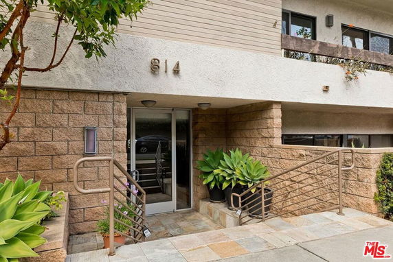 Front view of a building entrance with steps and railings.
