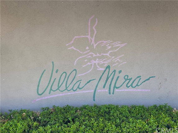 Exterior wall with Villa Mira sign and decorative elements.