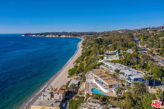 Panoramic view of oceanfront houses along the coastline.