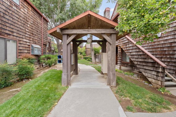 Front view of a rustic wooden building with a small covered walkway entrance.