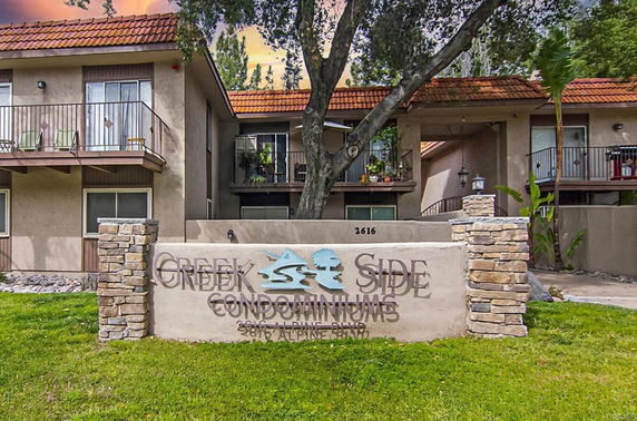 Front view of a two-story condominium building with balconies.