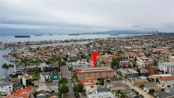 Aerial view of a coastal town with numerous buildings and a nearby body of water.