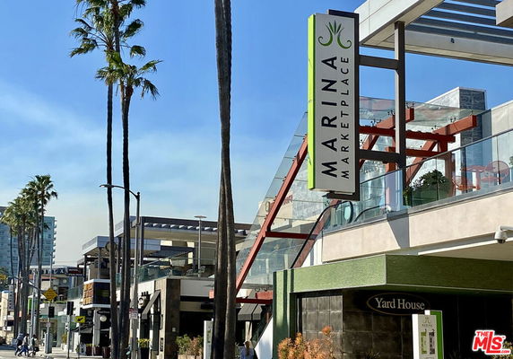 Front view of Marina Marketplace building with signage and architectural elements.