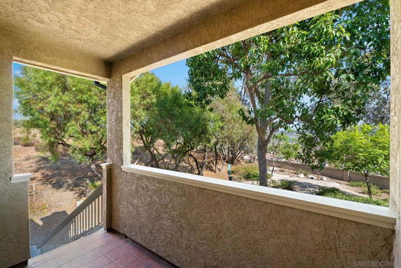 View from a building showing trees and a pathway outside.