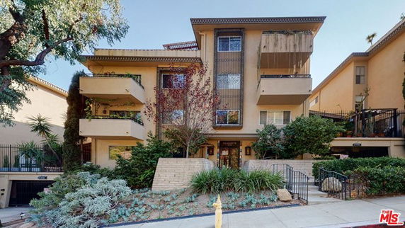 Front view of a multi-story residential building with balconies.