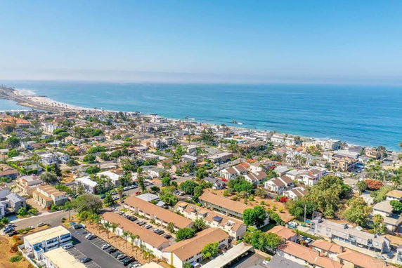 Panoramic view of a coastal residential area with ocean in the background.