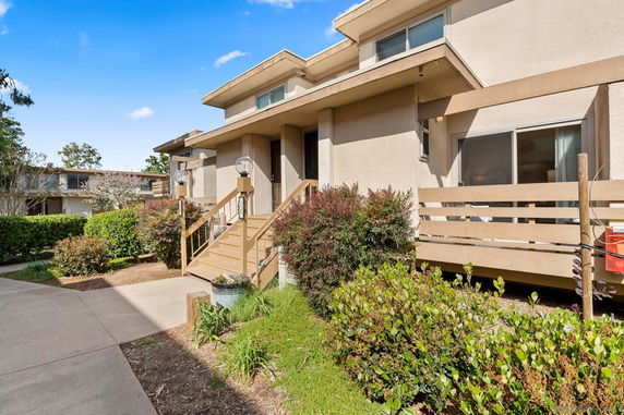 Front view of a residential building with steps leading to a small porch.