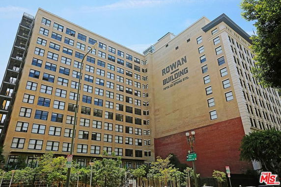 Front view of a multi-story building with large windows.