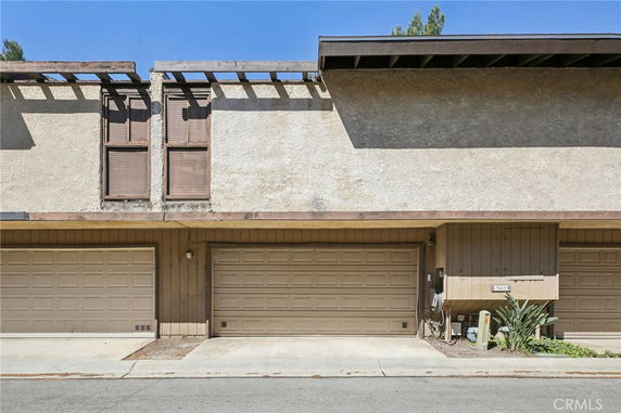 Front view of a townhouse with two garage doors.