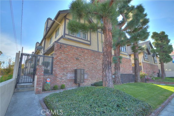 Front view of a two-story house with brick and stucco facade.