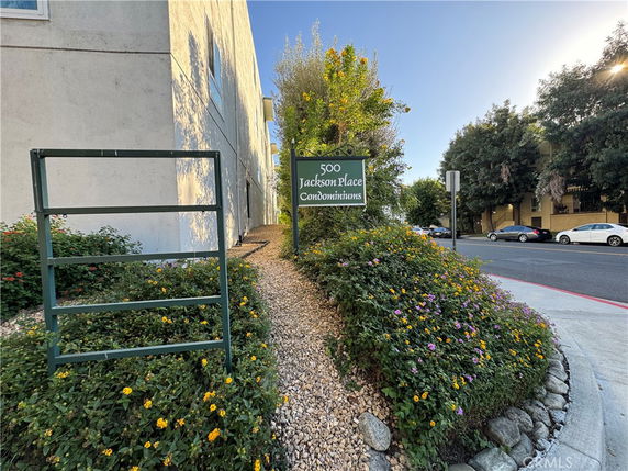 Front view of a building with a sign for Jackson Place Condominiums.