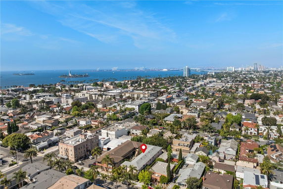 Panoramic view of a coastal cityscape with buildings and the ocean in the background.