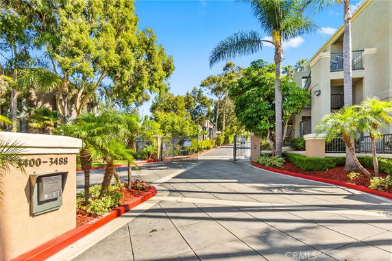 Front view of a multi-story residential building with gated entrance