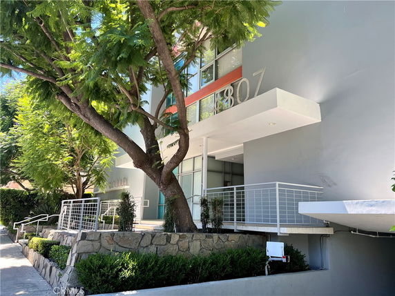 Front view of a building with modern architectural design and number 4807 on the facade.