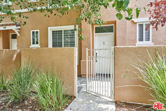 Front view of a townhouse entrance with a small gate and door marked 'C'.