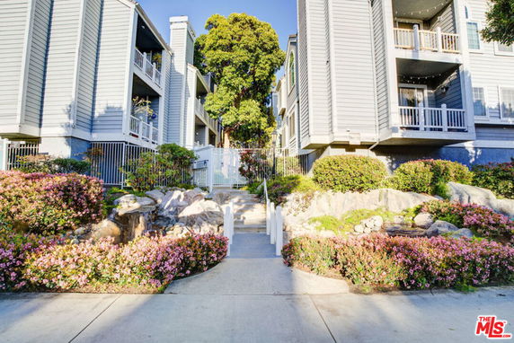 Front view of multi-story residential building with balconies.