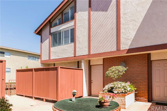 Front view of a two-story house with a red and beige color scheme.