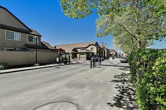 Front view of residential buildings with gated entrance.