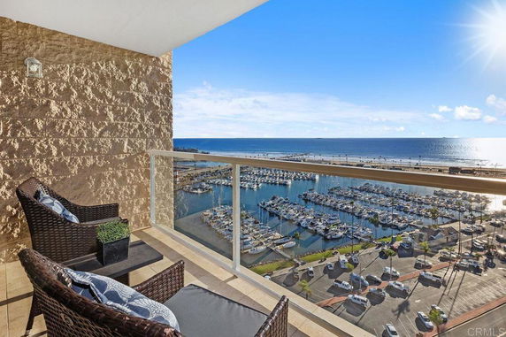 Balcony view overlooking a marina and ocean.