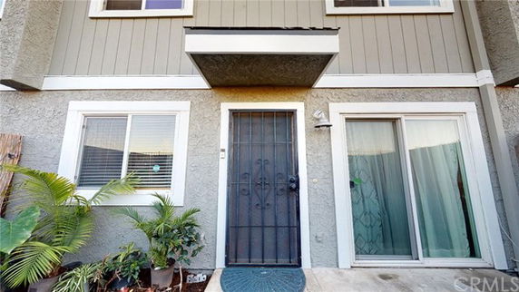 Front view of a multi-story house with a covered entrance.